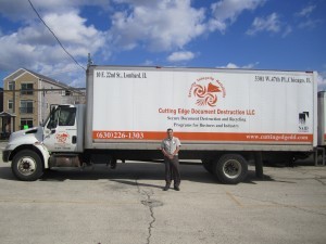 A man standing in front of a large truck.