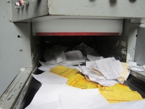 A pile of papers in an open machine.